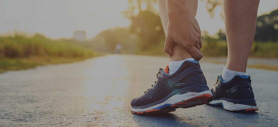 Runner rubbing their ankle